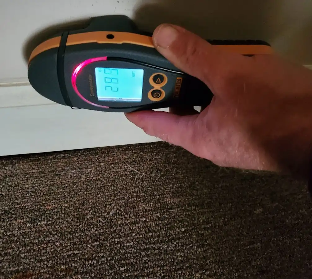 Moisture detection at baseboard during Storm Damage Restoration in Overland Park